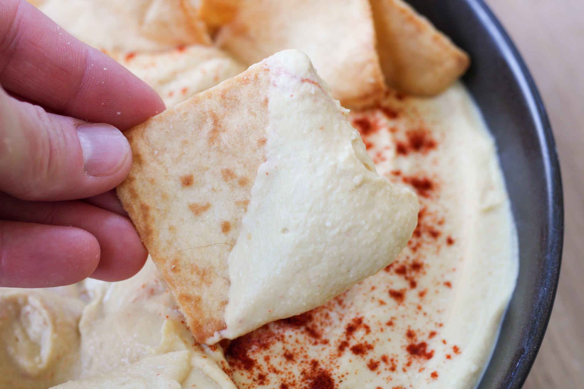 scoop of hummus on a pita chip